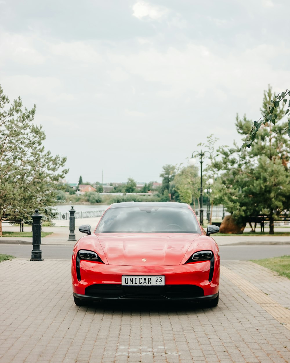a red sports car parked on a brick road
