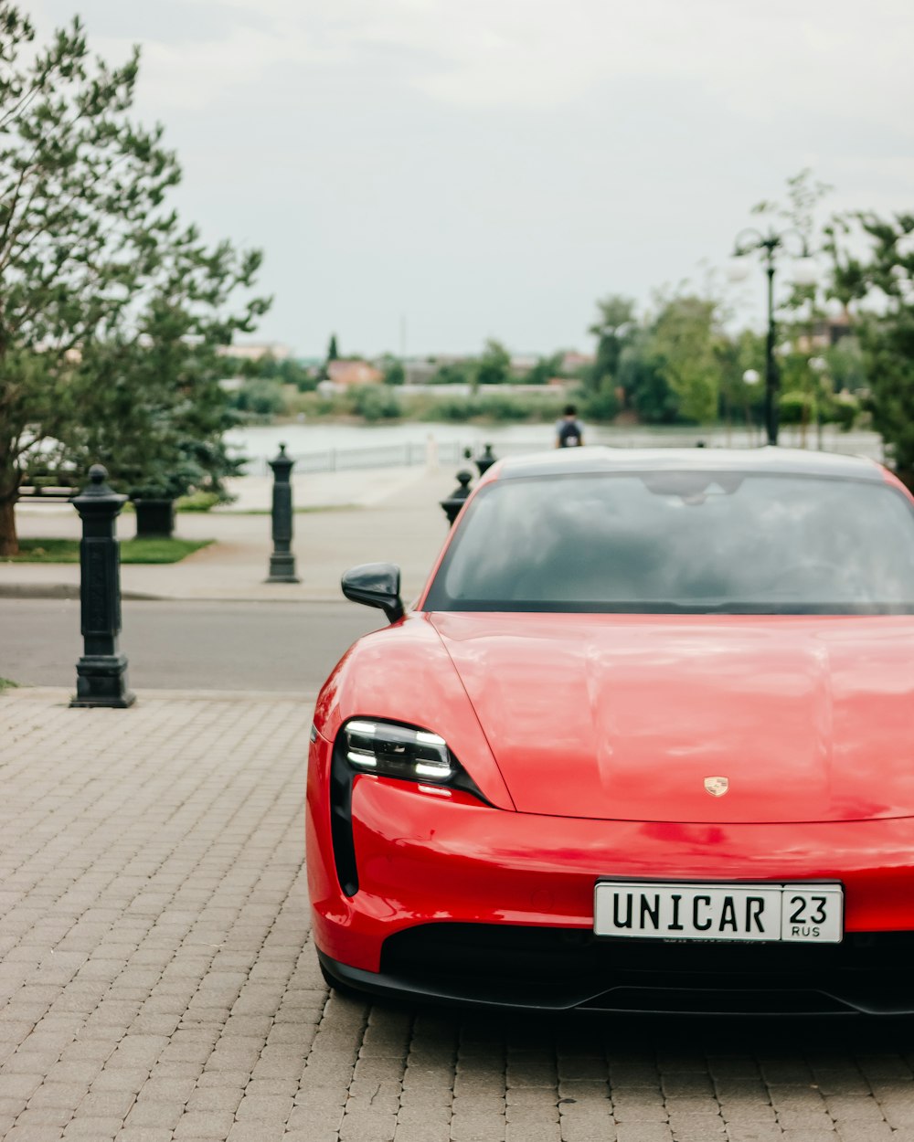 a red car parked on a brick road