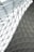 A geometric glass and steel roof structure with triangular panels forming a lattice pattern. The design creates a modern and intricate architectural element.