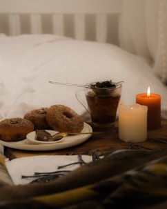 a table with plates of food and candles