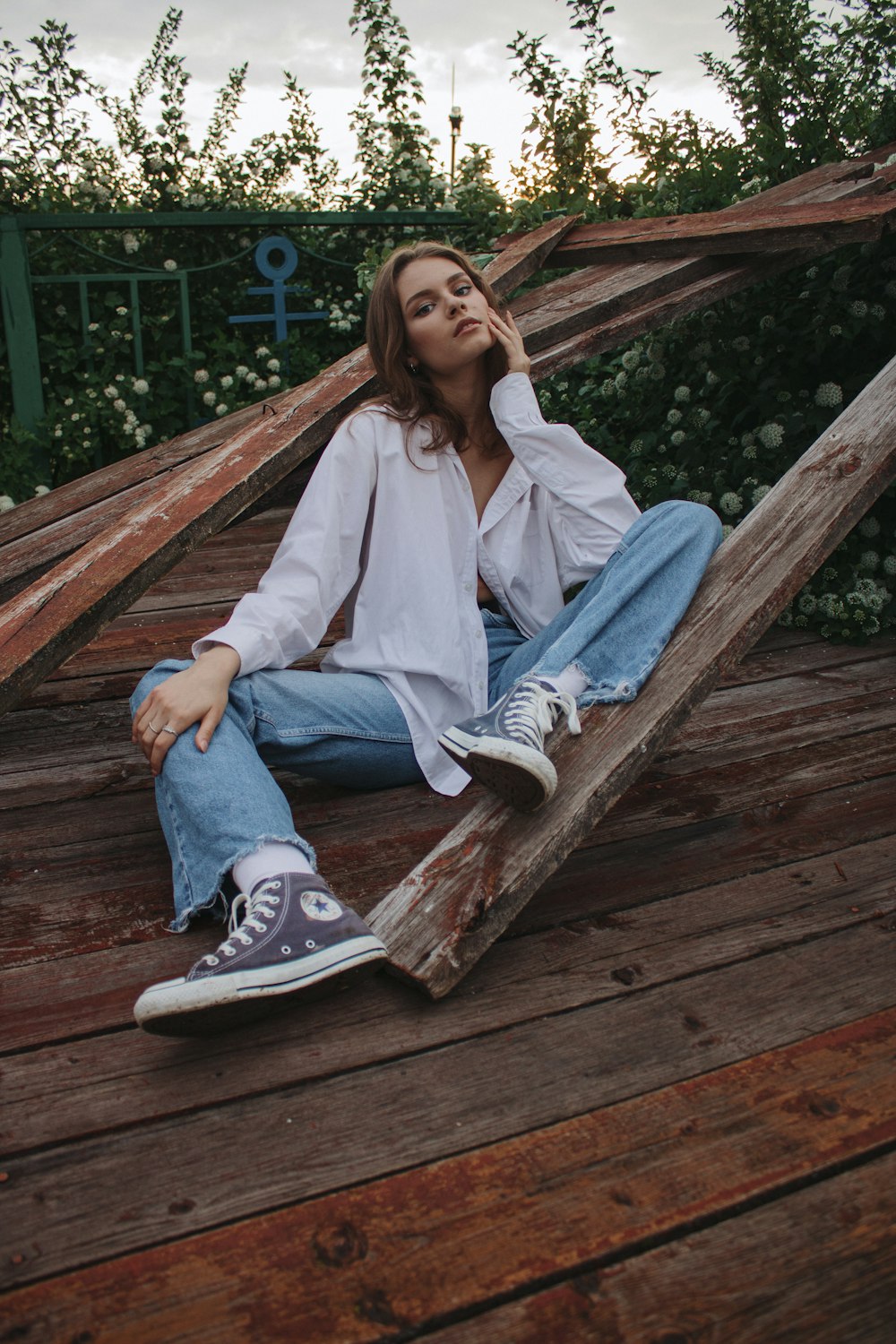 a person sitting on a wooden deck