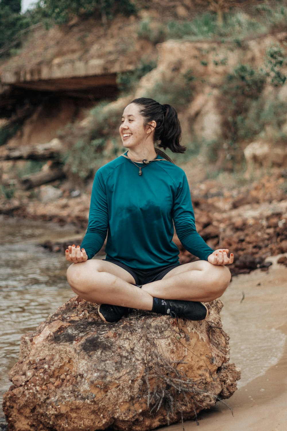 a person sitting on a rock