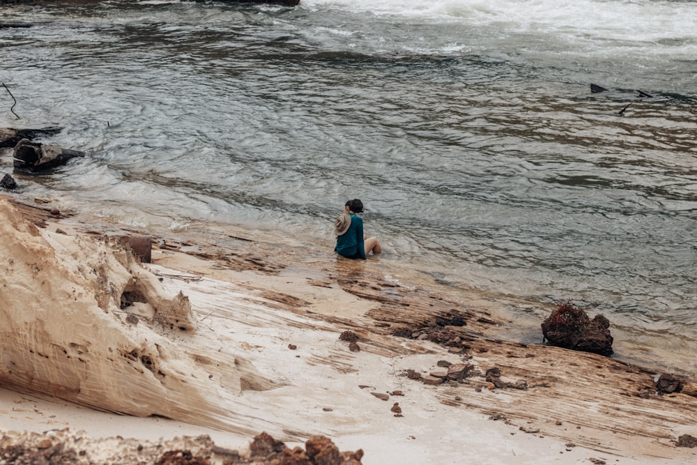 a man sitting on a beach