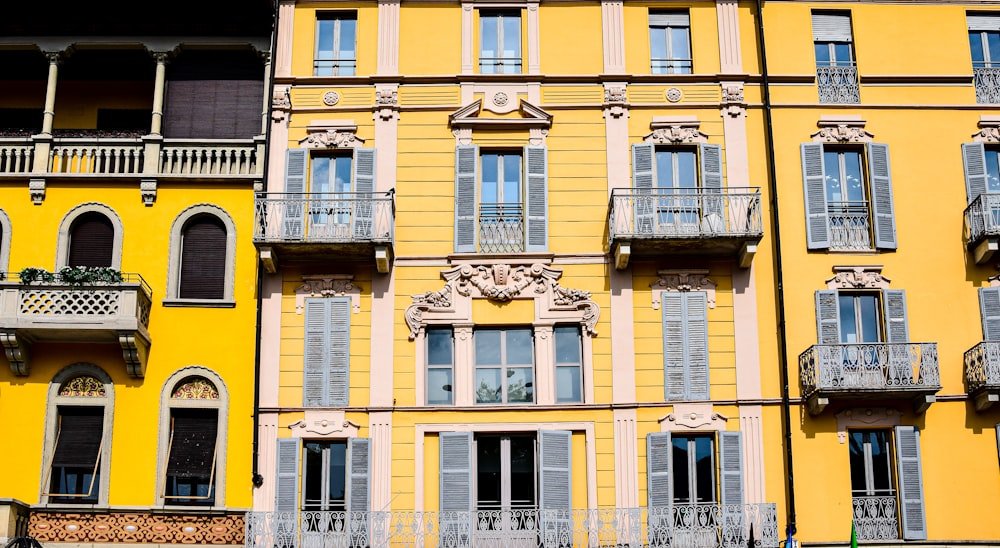 a yellow building with balconies