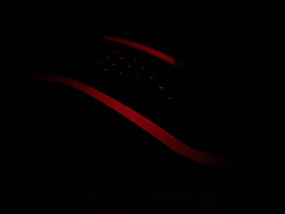 Close-up of a sleek, elegant adult product with soft lighting highlighting its curves.