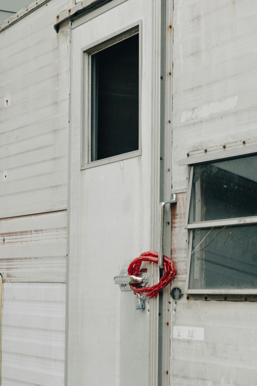 a red hose attached to a white building