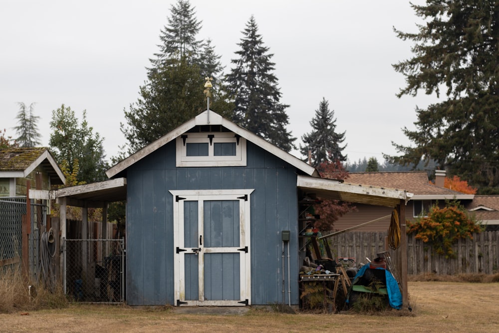 a blue house with a few people outside