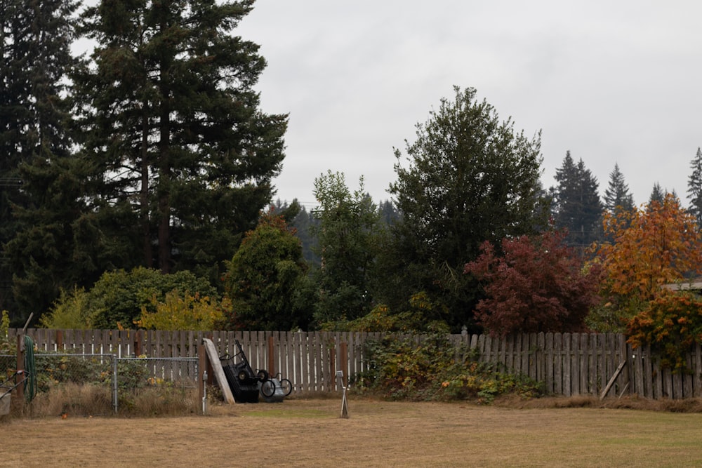 a fenced in field with trees