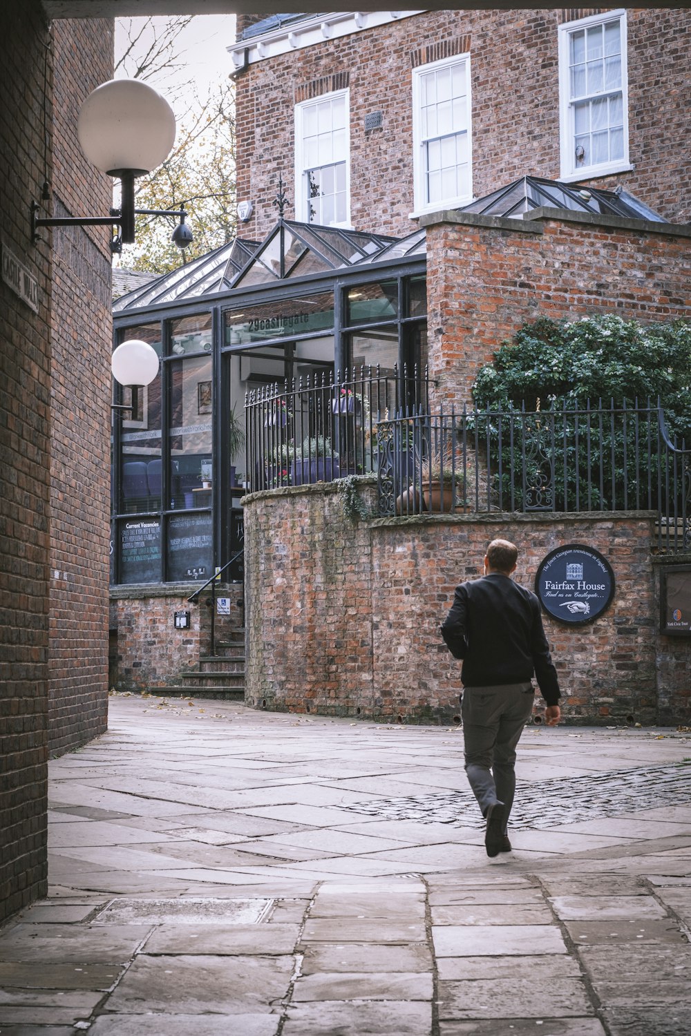 a man walking on a sidewalk