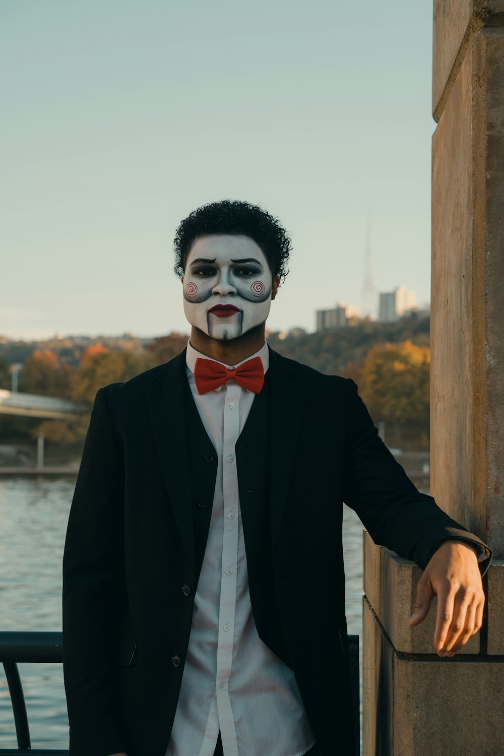 a man in a suit and bow tie with a face paint