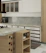 Cozy modern kitchen interior featuring custom wooden cabinetry and sleek black countertops.