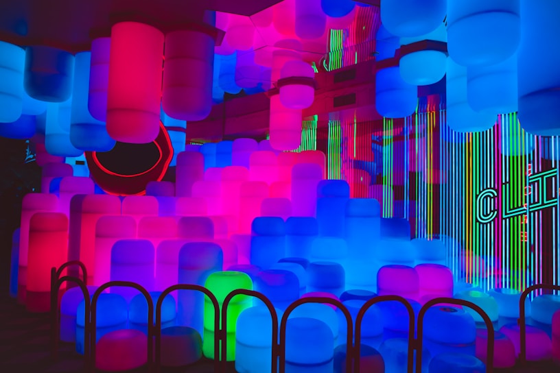 A vibrant party scene inside Space Fun with glowing purple and blue galactic decorations.