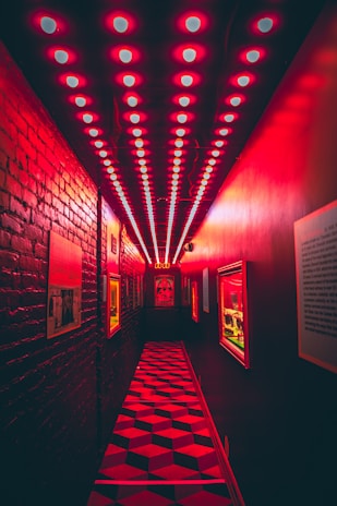 A stark hallway with peeling paint and a single redacted document pinned to the wall, symbolizing hidden truths.