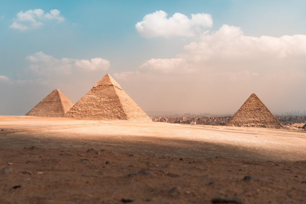 a group of pyramids in a desert