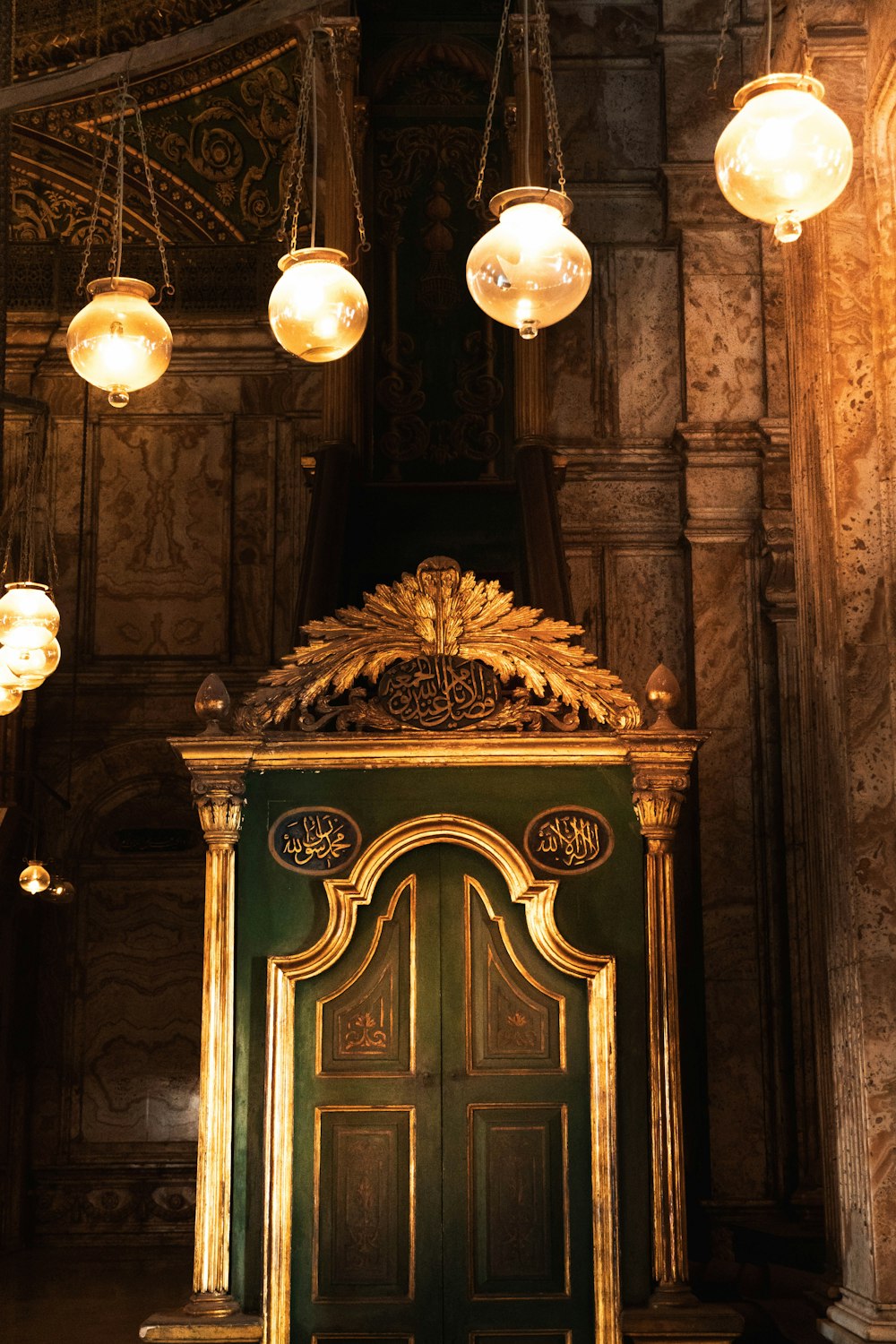 a door with chandeliers above it