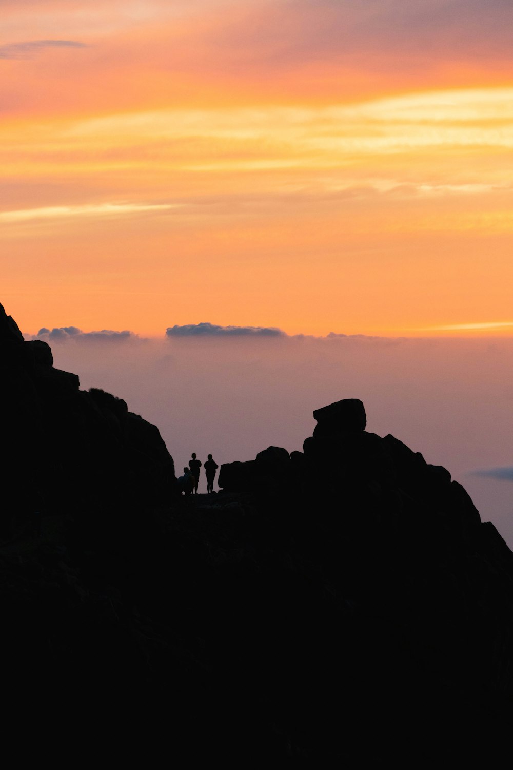 a group of people standing on a mountain