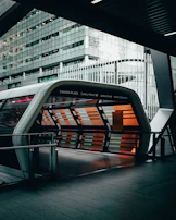 Automated building entrance with orange and gray design elements.