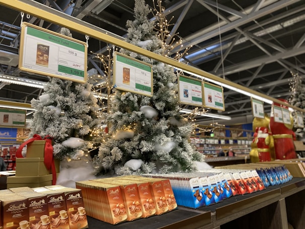 A festive seasonal display featuring Sweety Industries products with decorative lights.