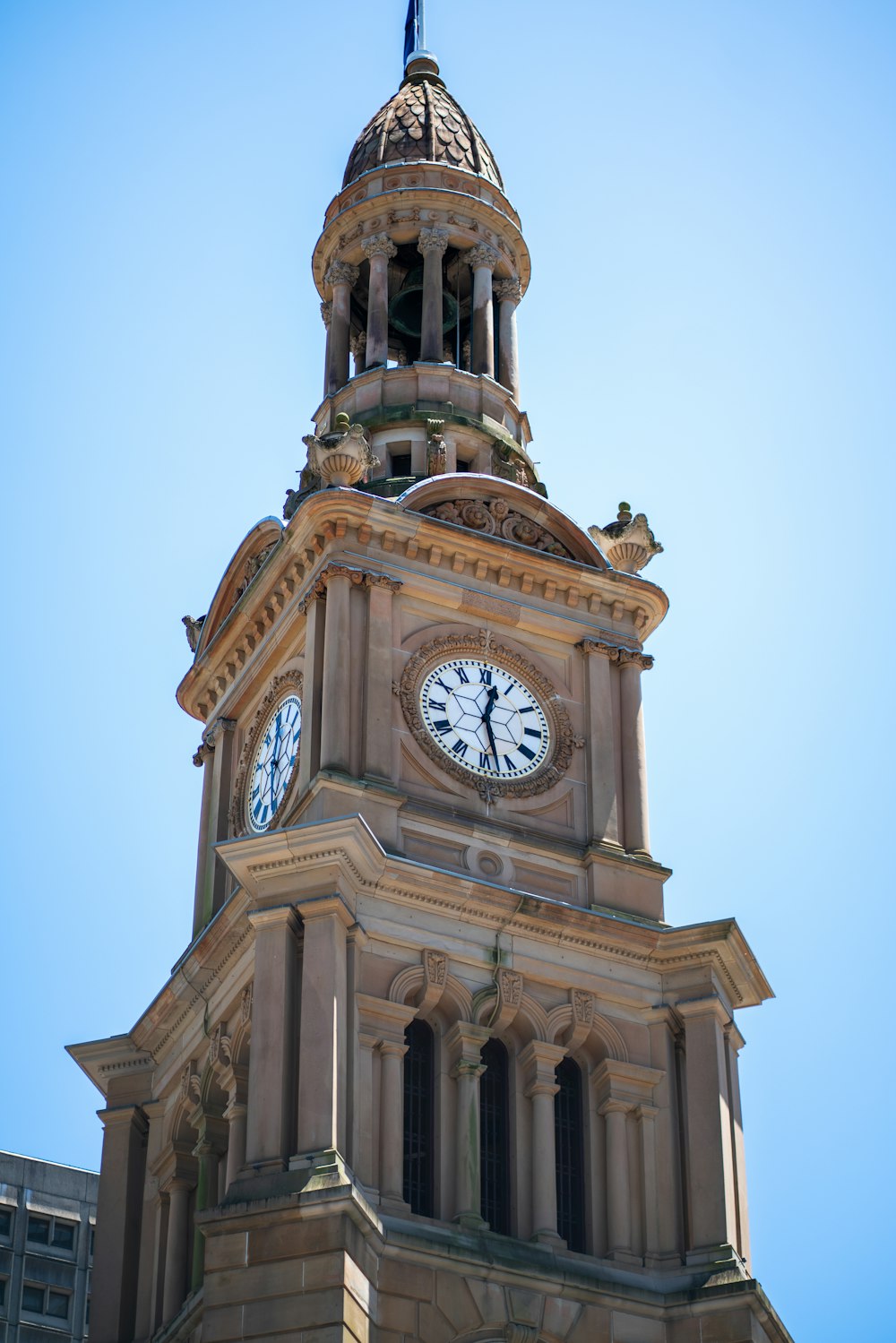 a clock tower with a weather vane