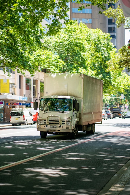 a truck driving down a street