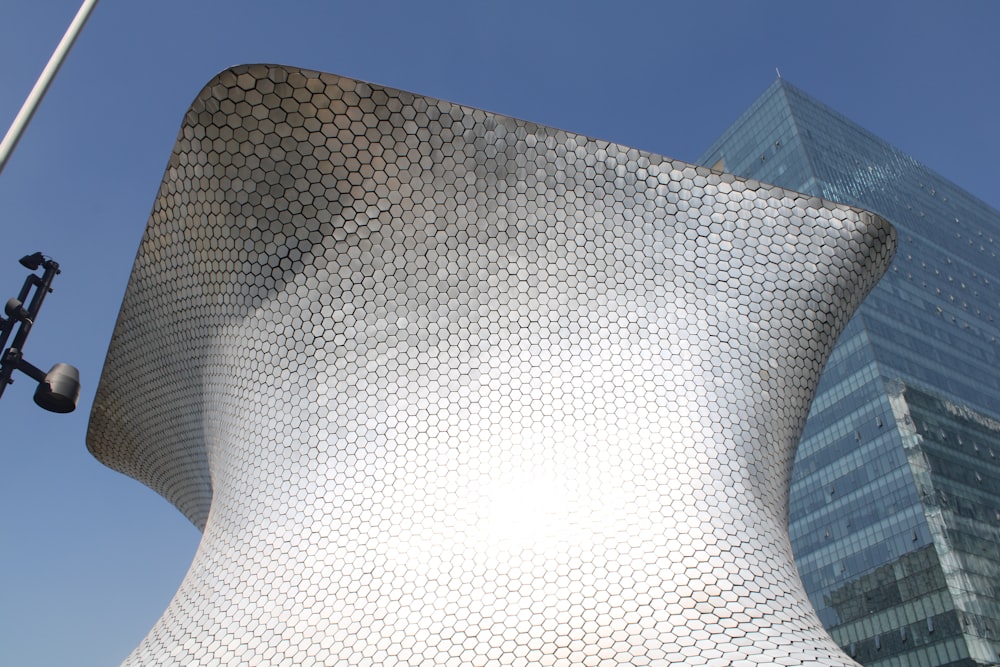 a large white spherical structure with Museo Soumaya in the background