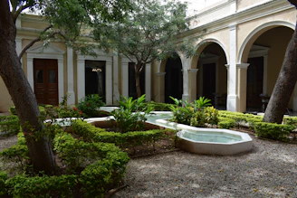 a large white building with a pool
