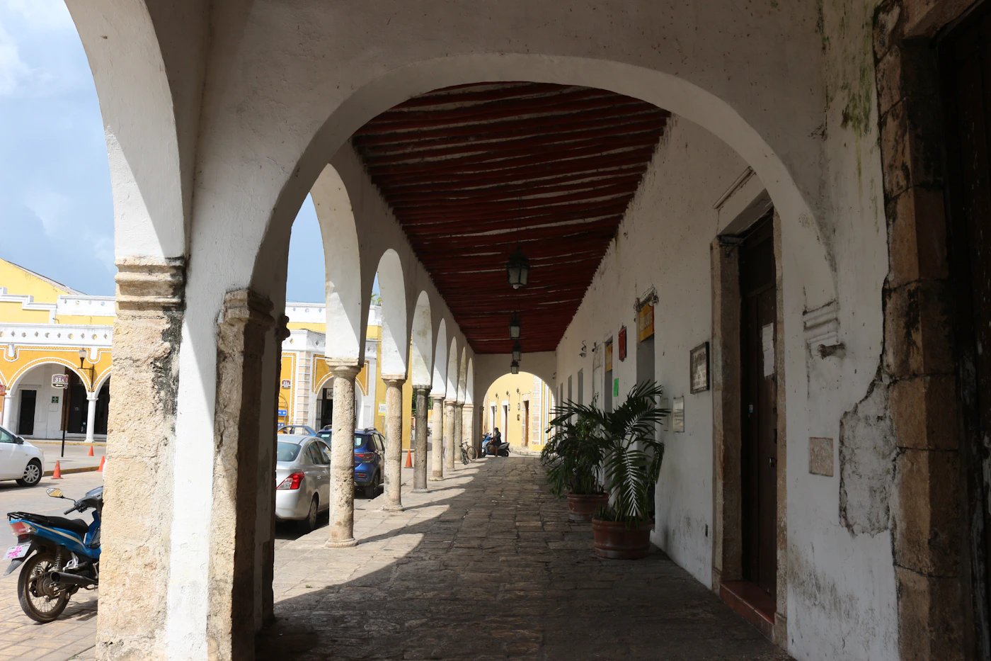 Street in Izamal Yucatan Mexico with the characteristic ochre yellow colonial buildings and arched architecture of this single-colour painted town