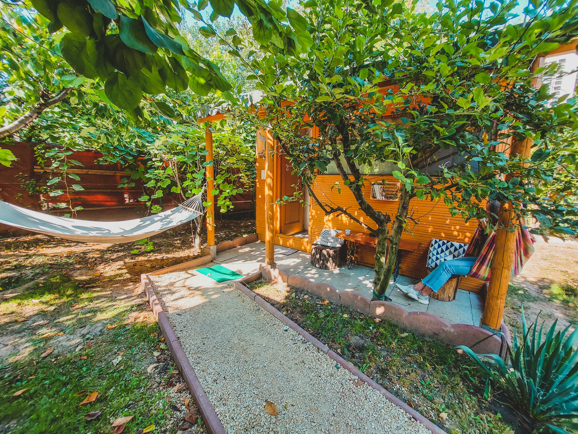woman wearing yellow long-sleeved dress under white clouds and blue sky during daytime