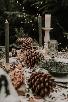 A festive table setting with biodegradable Christmas garlands and natural pinecone decorations glowing under warm lights.