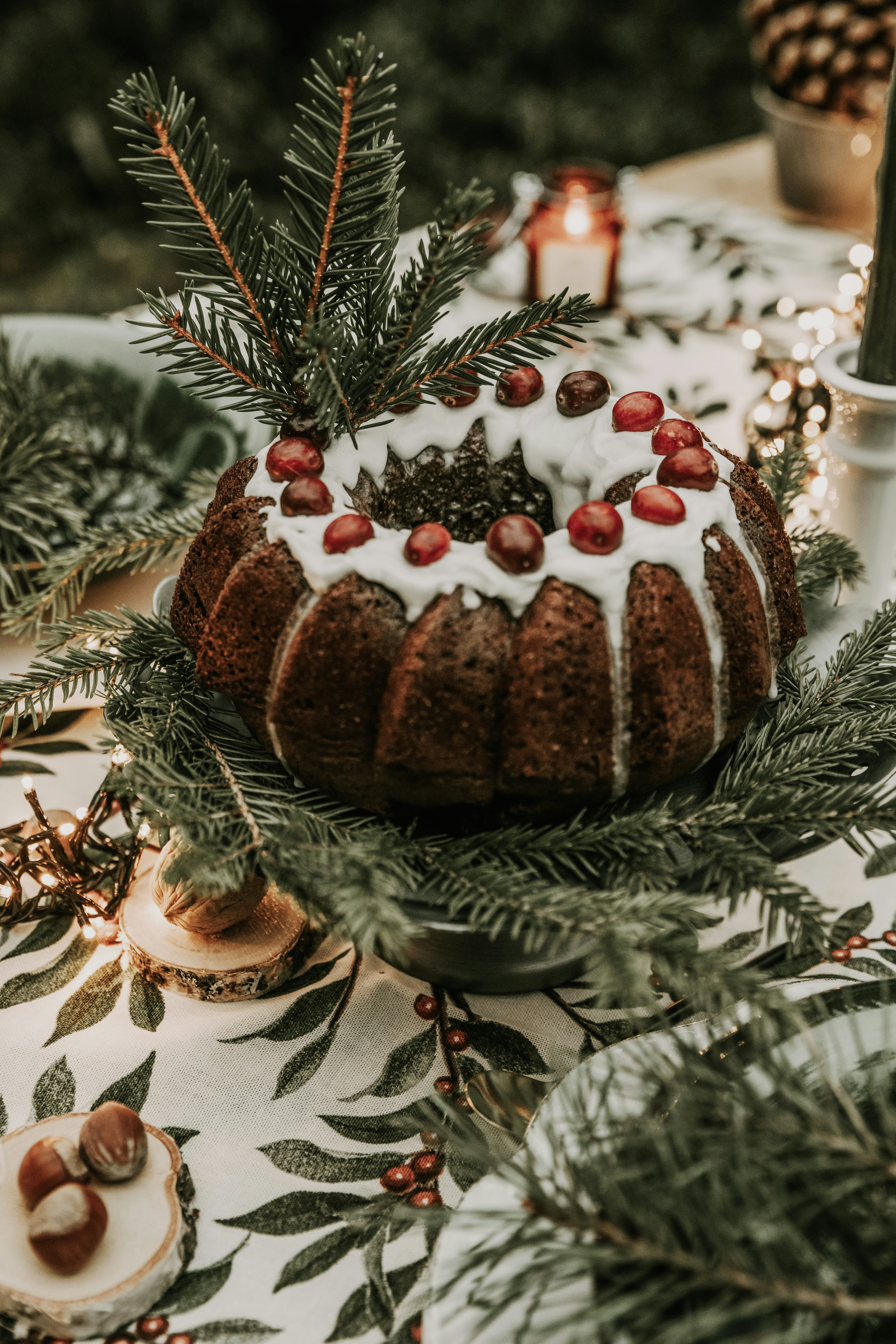 a gingerbread house with a pine tree in the background