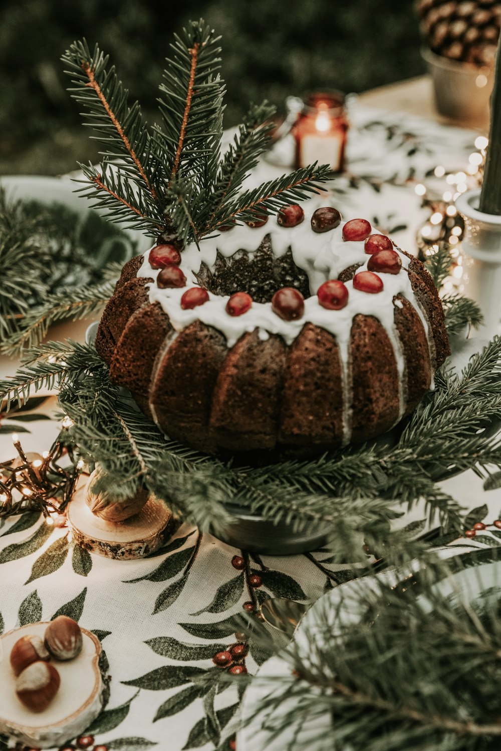 a gingerbread house with a pine tree in the background