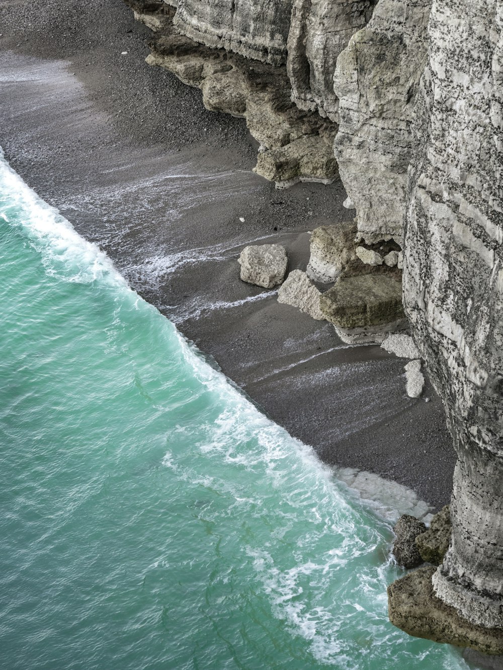 a rocky beach with a body of water