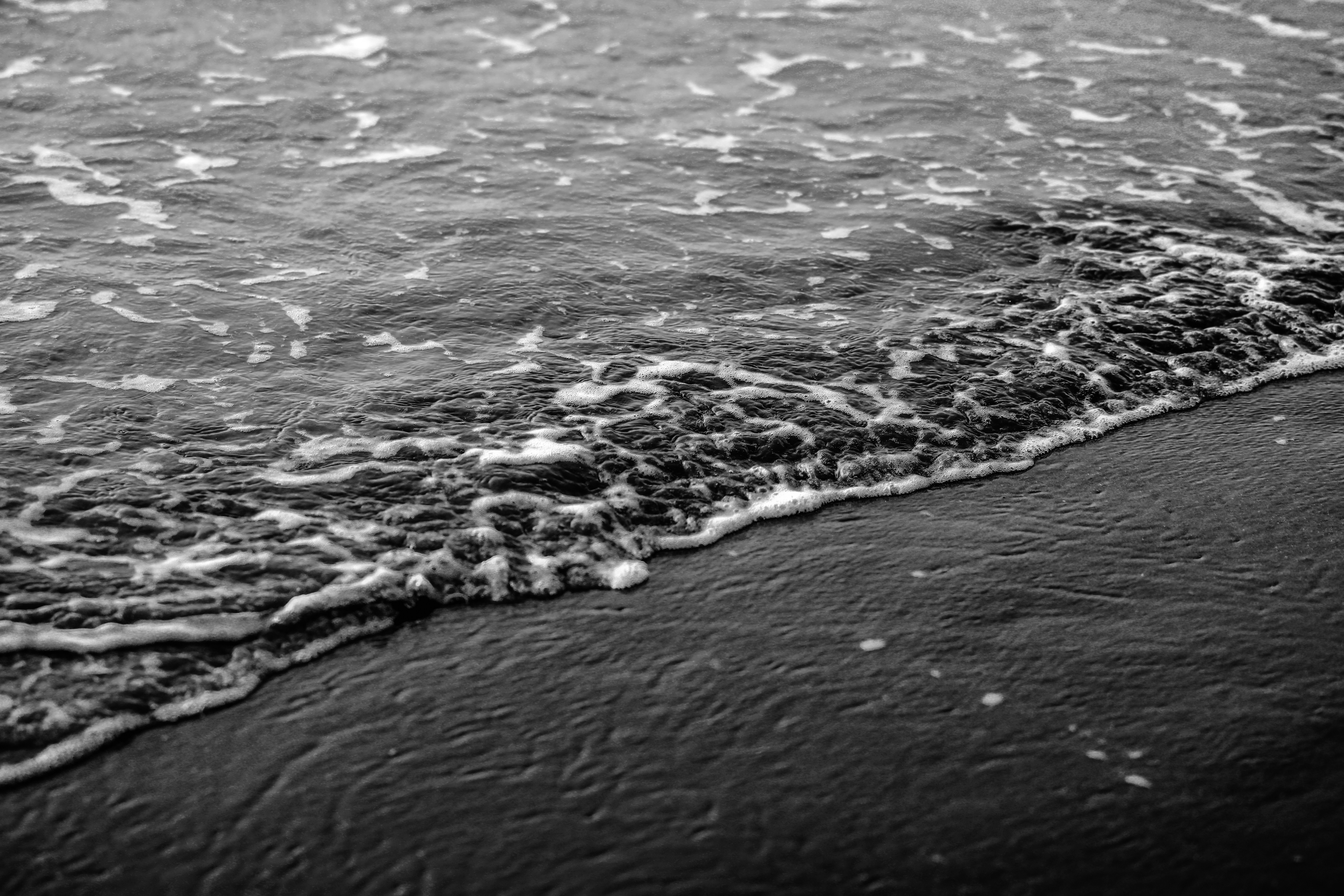 a black and white photo of a wave