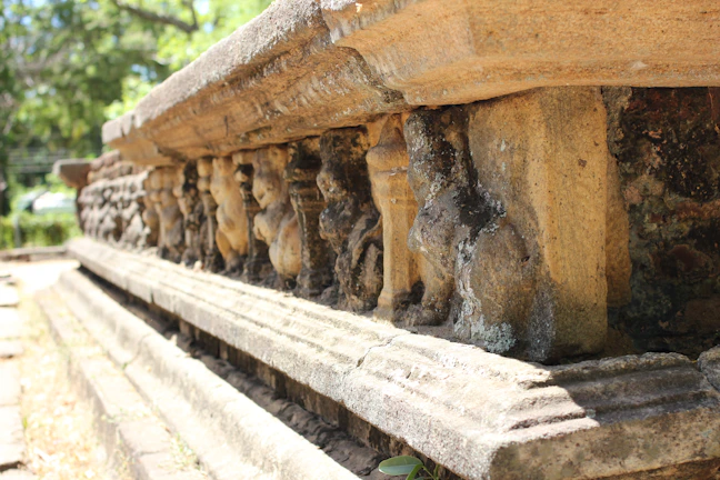 Intricate carvings on a moss-covered megalith, hinting at forgotten wisdom.