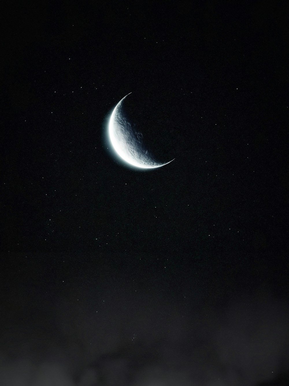 a crescent moon in the night sky