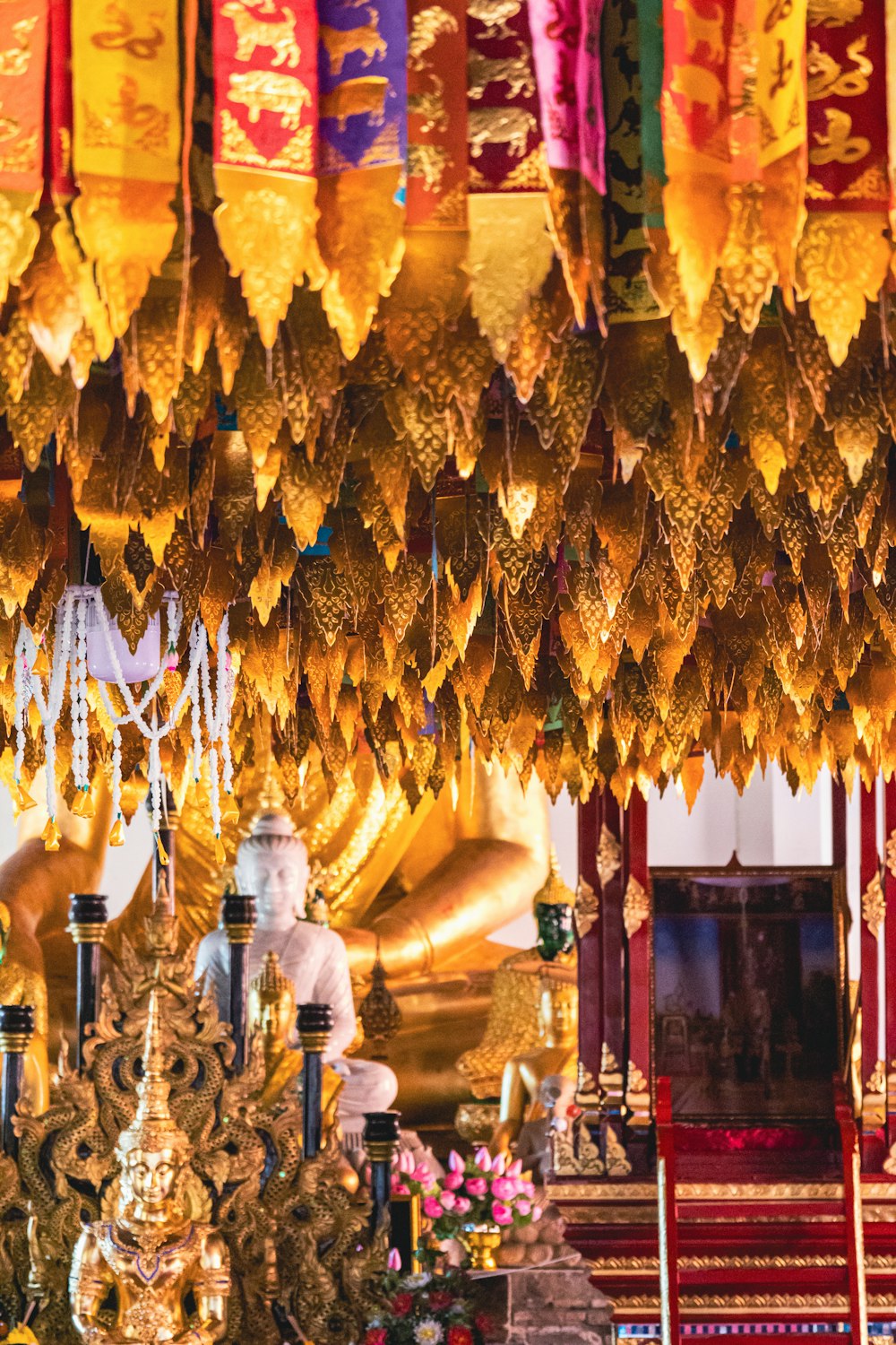 a shrine with a statue and flags