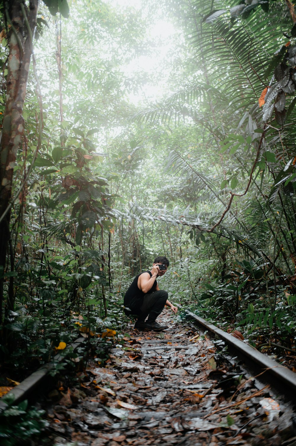 a person sitting on a railroad track