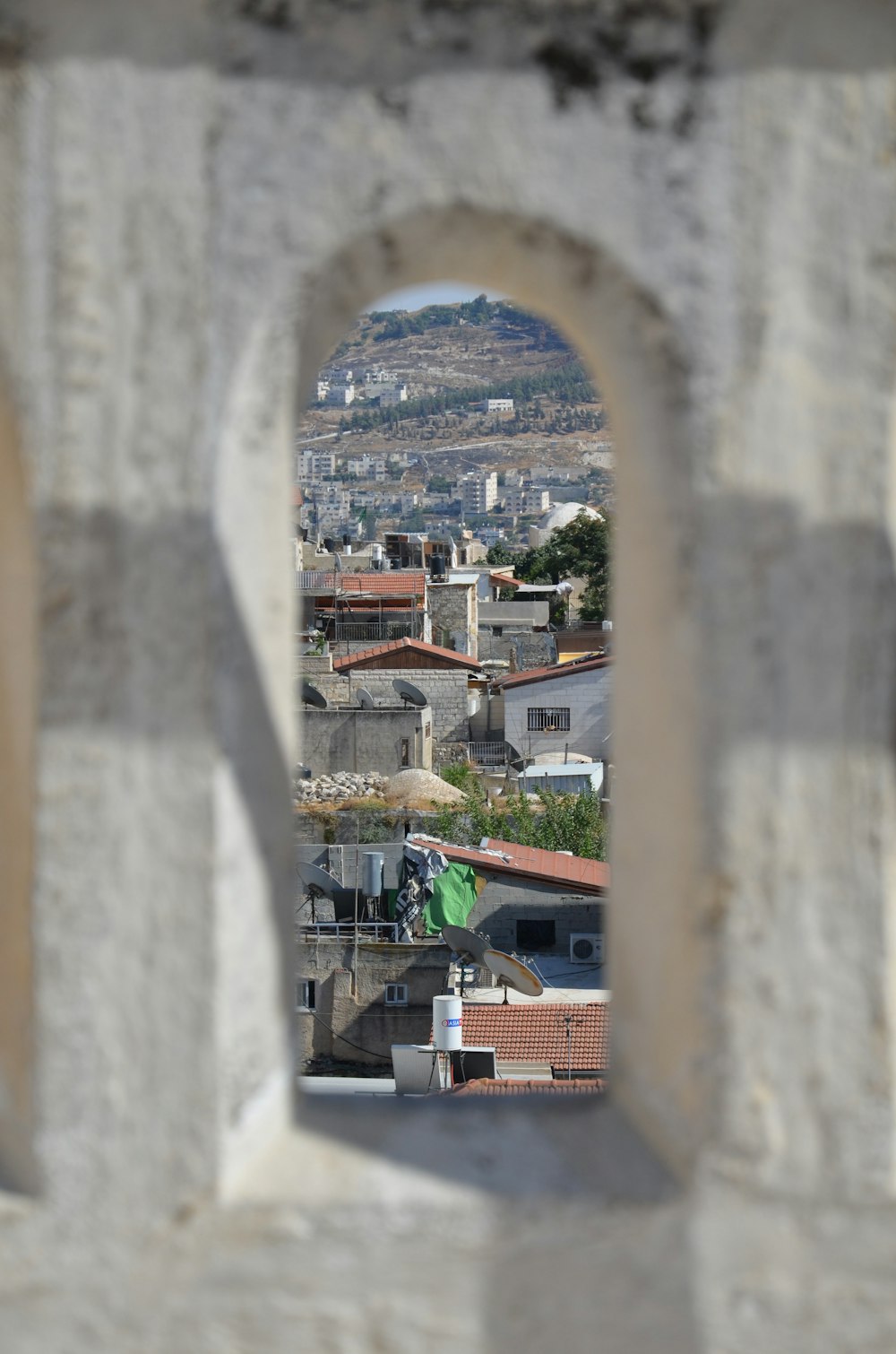 a view of a town through a stone archway
