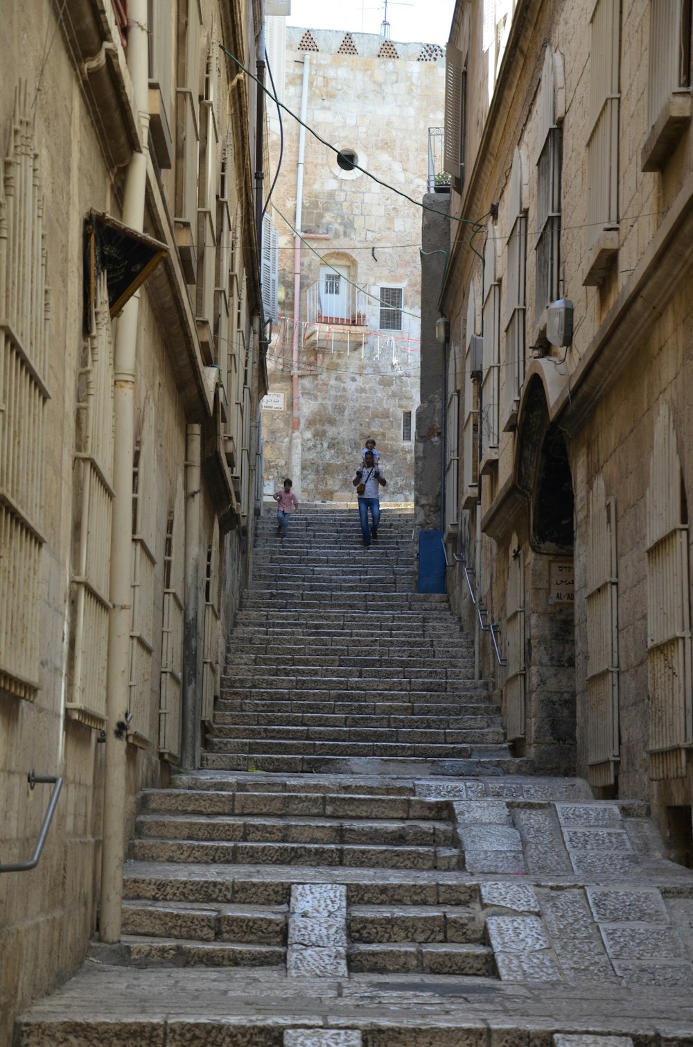 people walking down a stone staircase