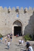 a group of people walking into a castle