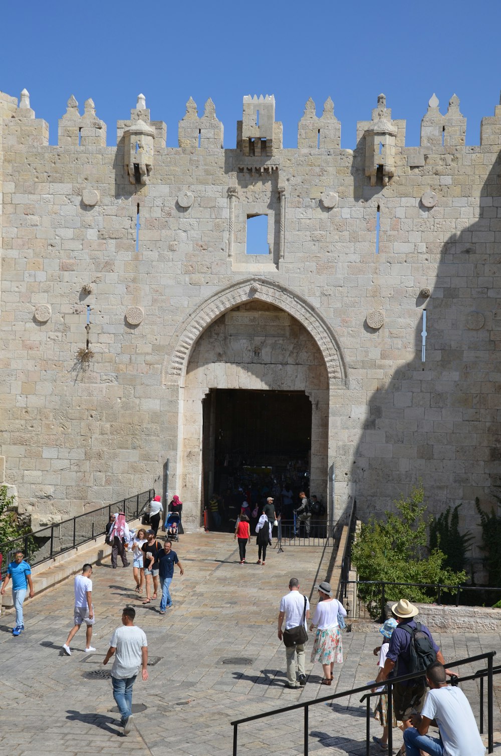 a group of people walking into a castle