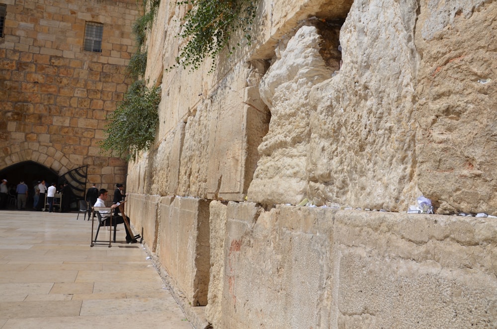 people sitting at a table in a stone building