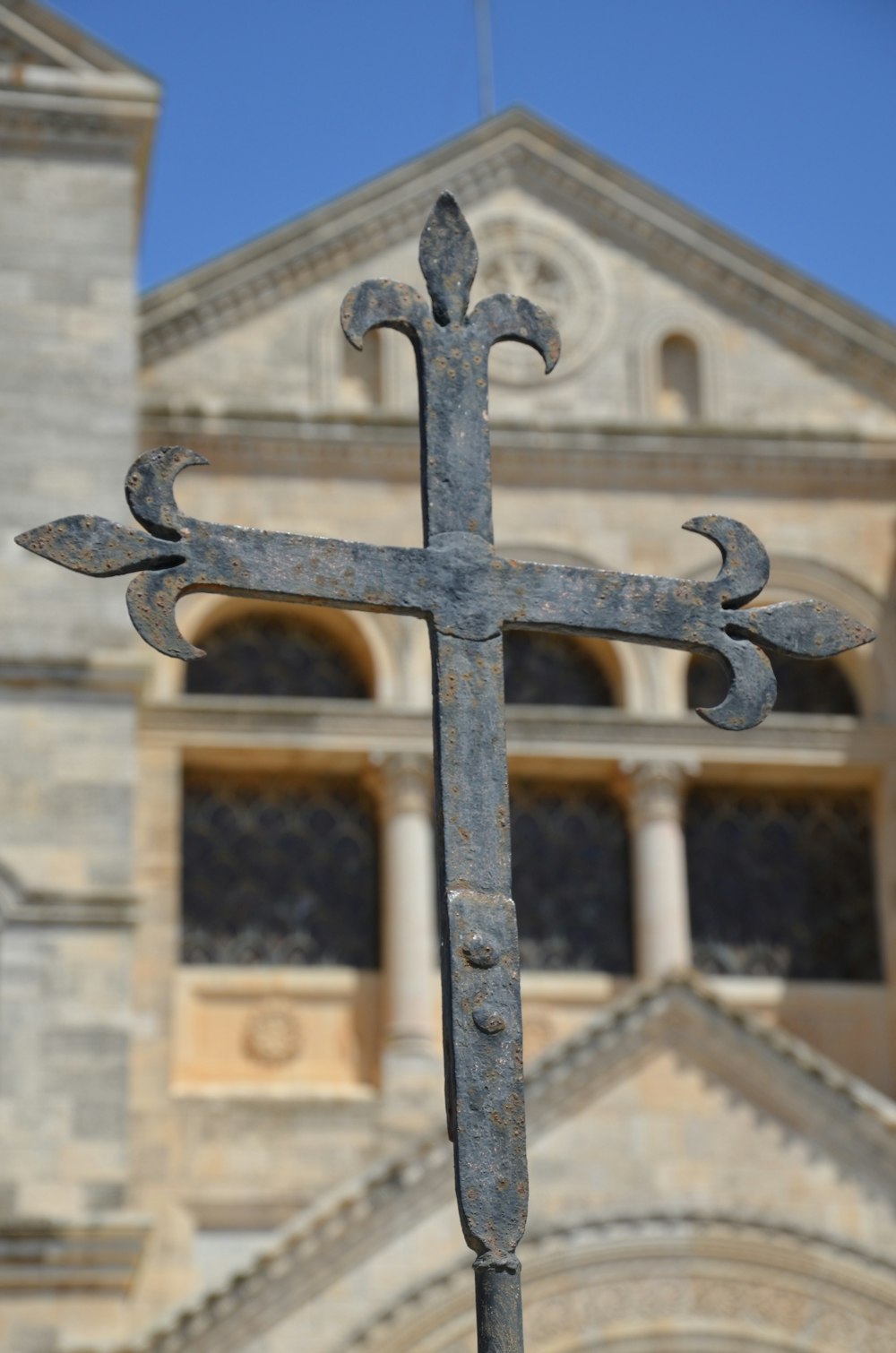 a cross in front of a building