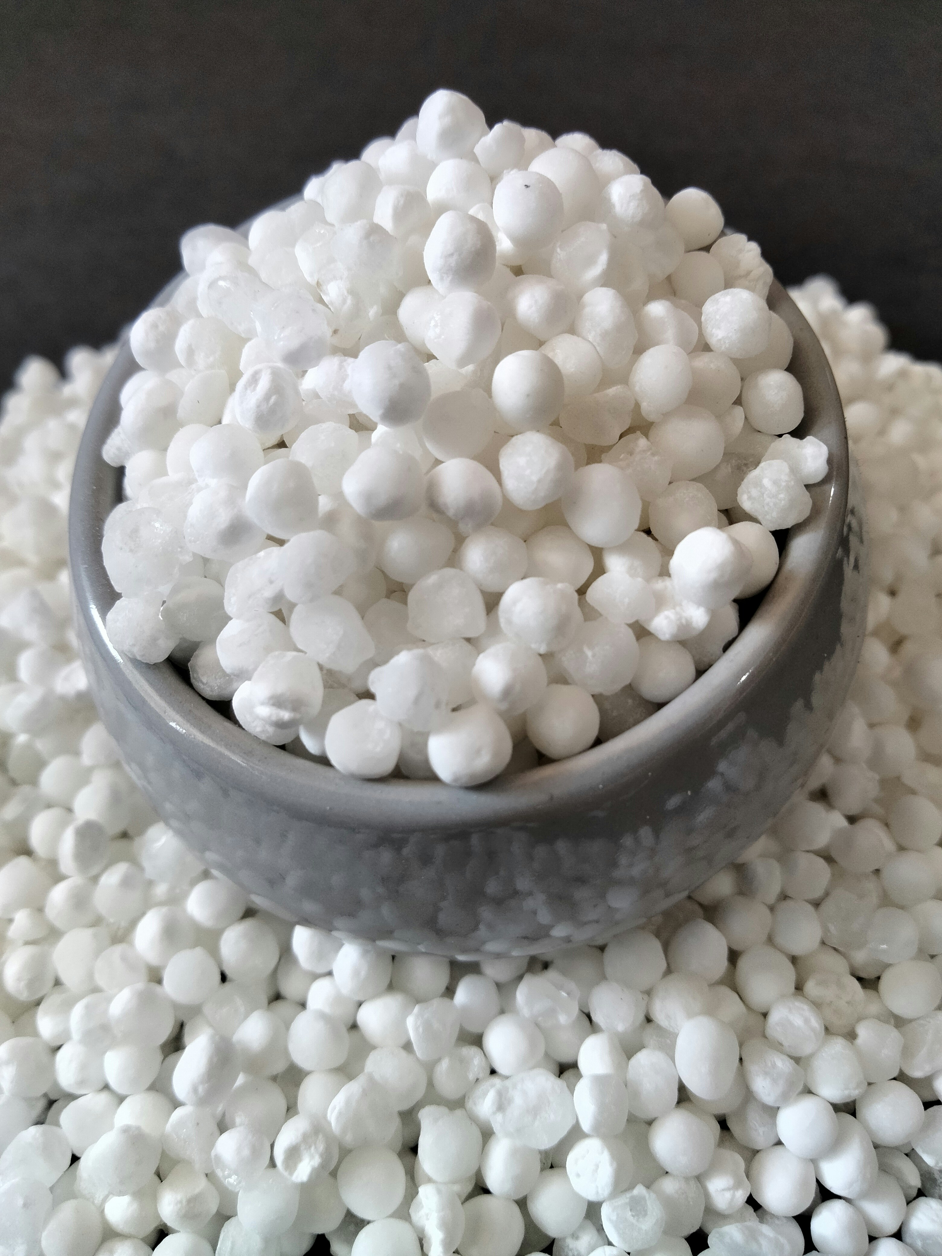 White tapioca pearls on dark atmospheric background, dim cold storage lighting