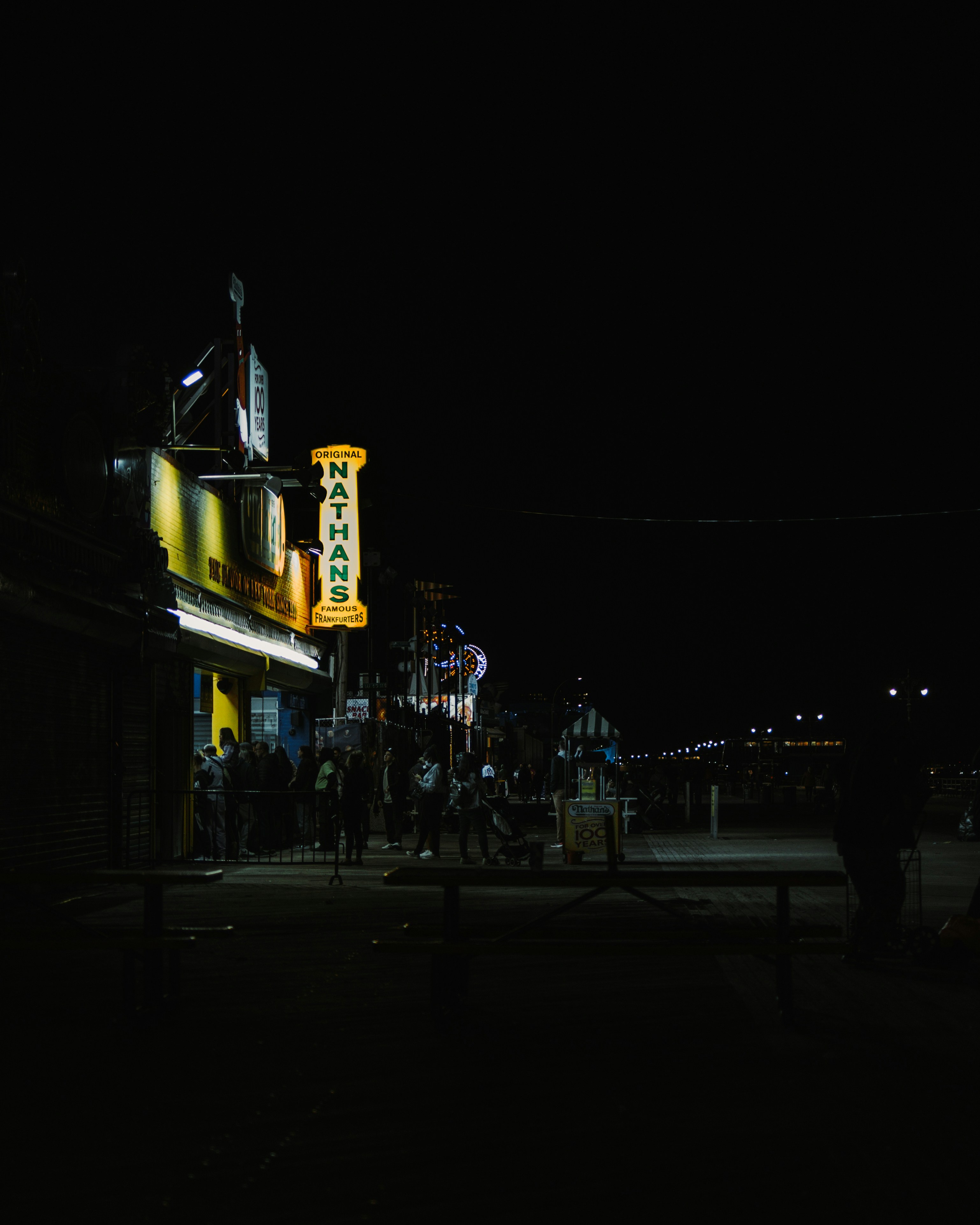 a group of people standing outside a building at night