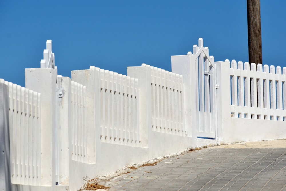 a row of white picket fence