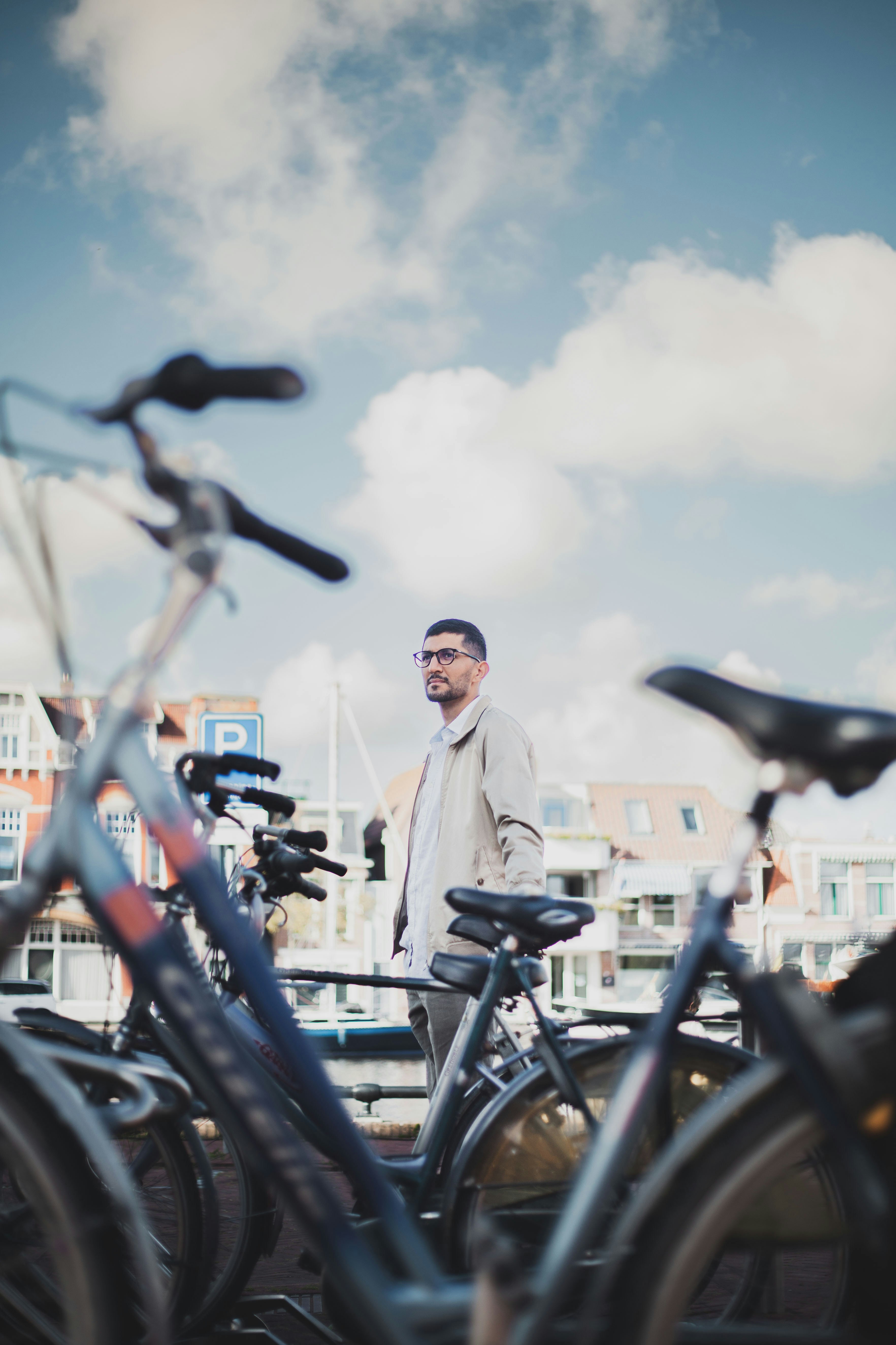a man standing next to a row of bicycles