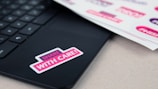 Stickers with bold messages of truth, mercy, and justice displayed on a laptop.