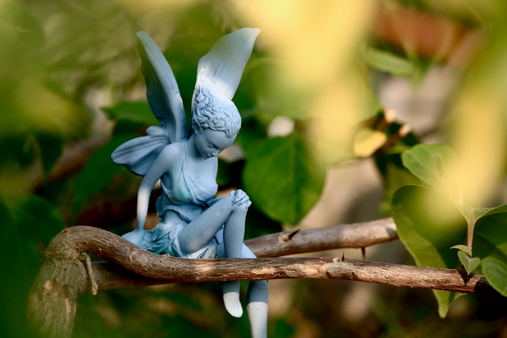 a blue flower on a branch