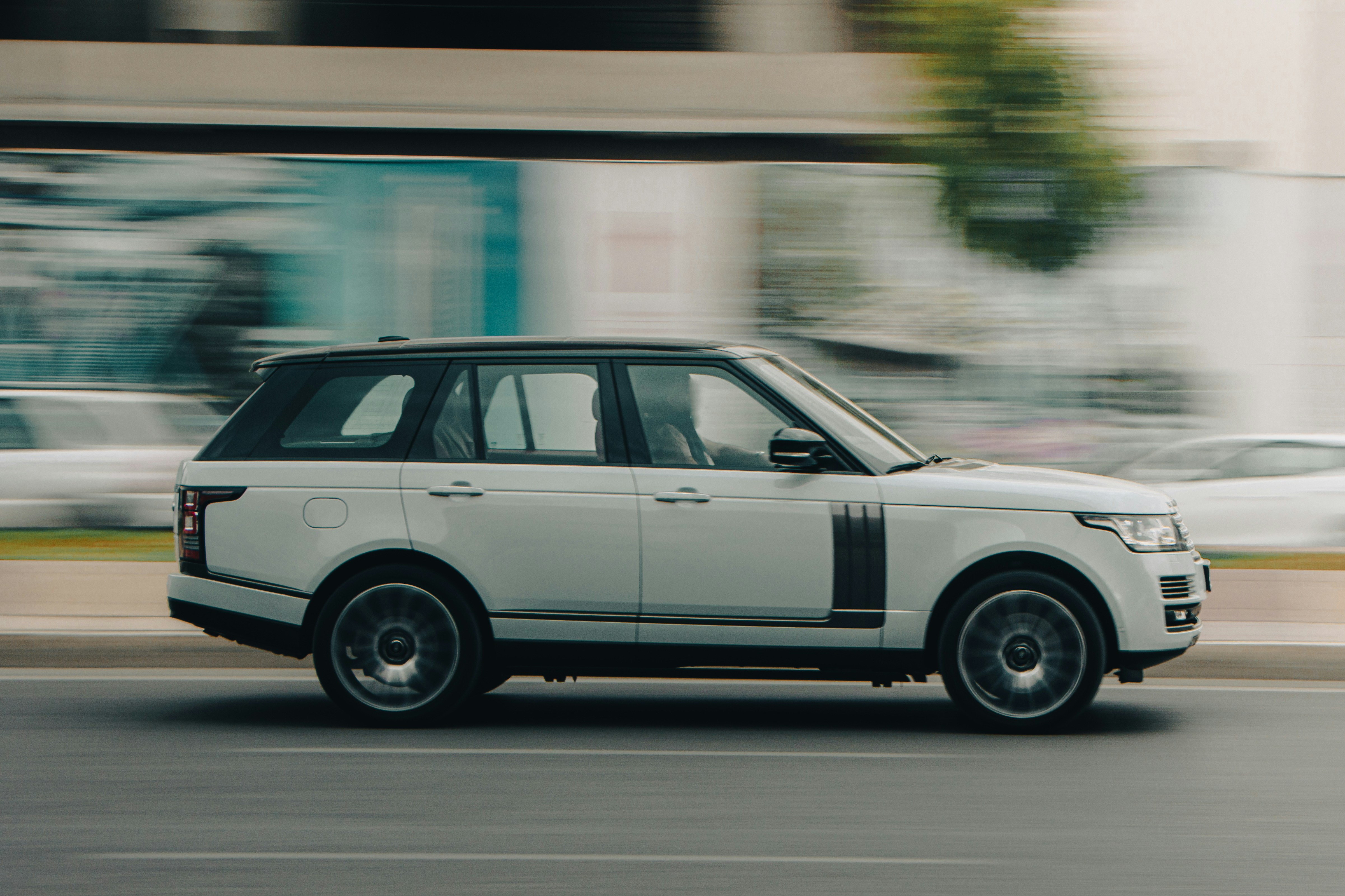 a white car driving on a road